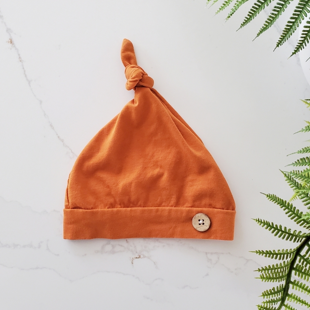 Burnt Orange baby cap with wooden button accent